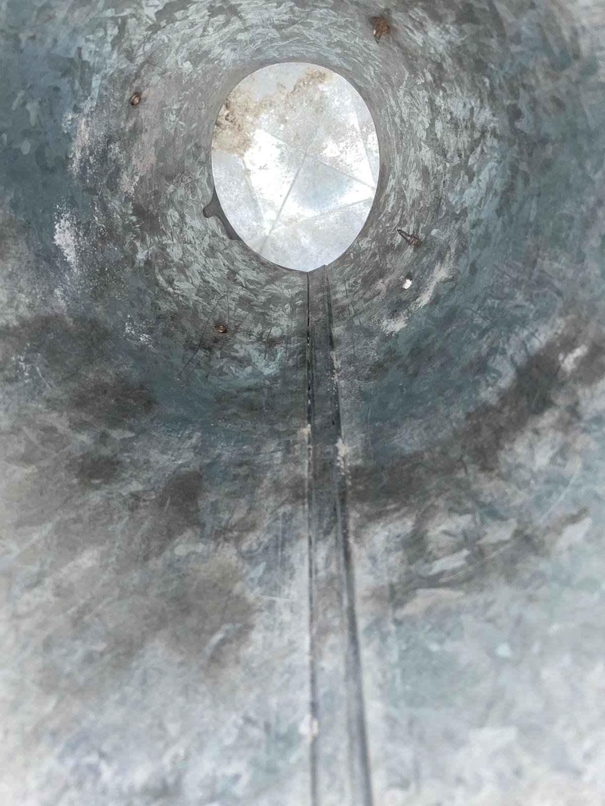 Dryer vent cap and screws coated in dust before cleaning in Sugar Land, TX 77498